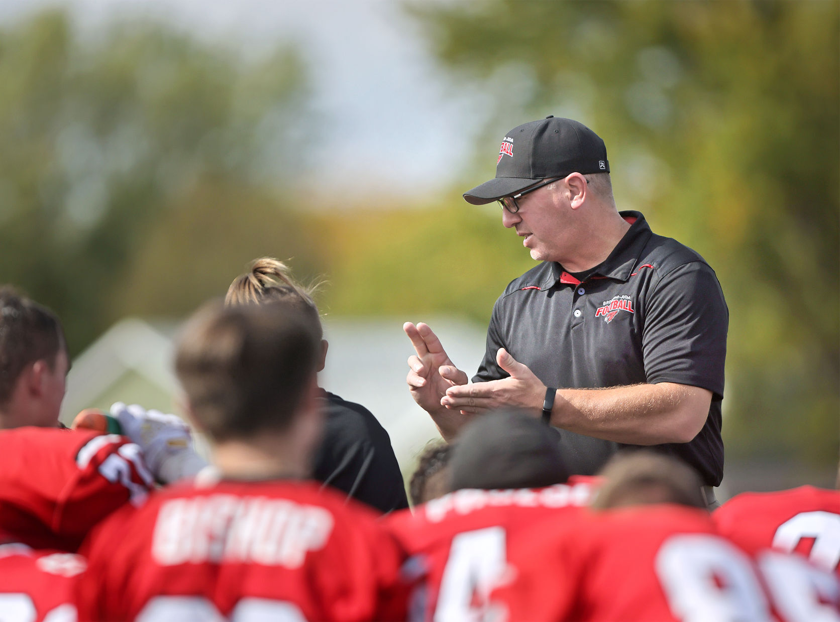 Brodhead football players listen to coach Jim Matthys